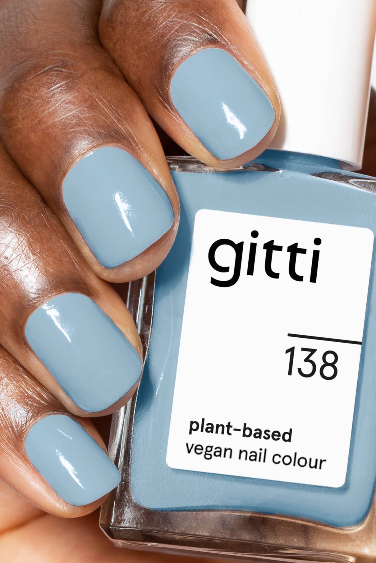 Nahaufnahme einer Hand mit hellblauen Nägeln, die gitti no. 138 pflanzlicher veganer Nagellack - ein kühler Farbton, inspiriert von hellem Denim-Blau.