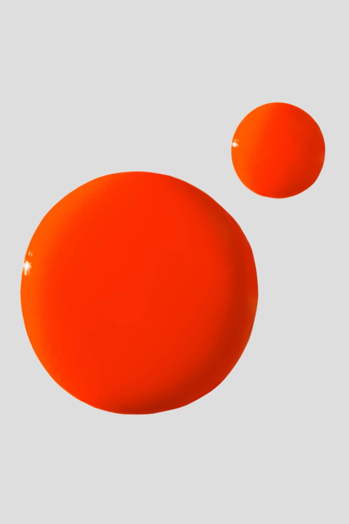 Zwei glänzende, leuchtende Kugeln in gitti no. 139 - ein kräftiges Orangerot -, jede in einer anderen Größe, ruhen auf einem schlichten hellgrauen Hintergrund.