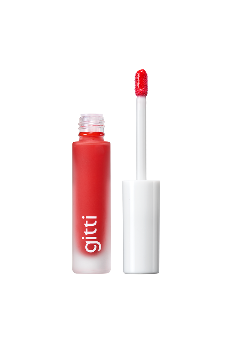 Lip Glaze no. 02, ein roter Flüssiglippenstift in einer gefrosteten Gitti-Tube mit weißem Applikator und rot getöntem Pinsel, liefert ein hochglänzendes Finish für einen gewagten, glänzenden Look.