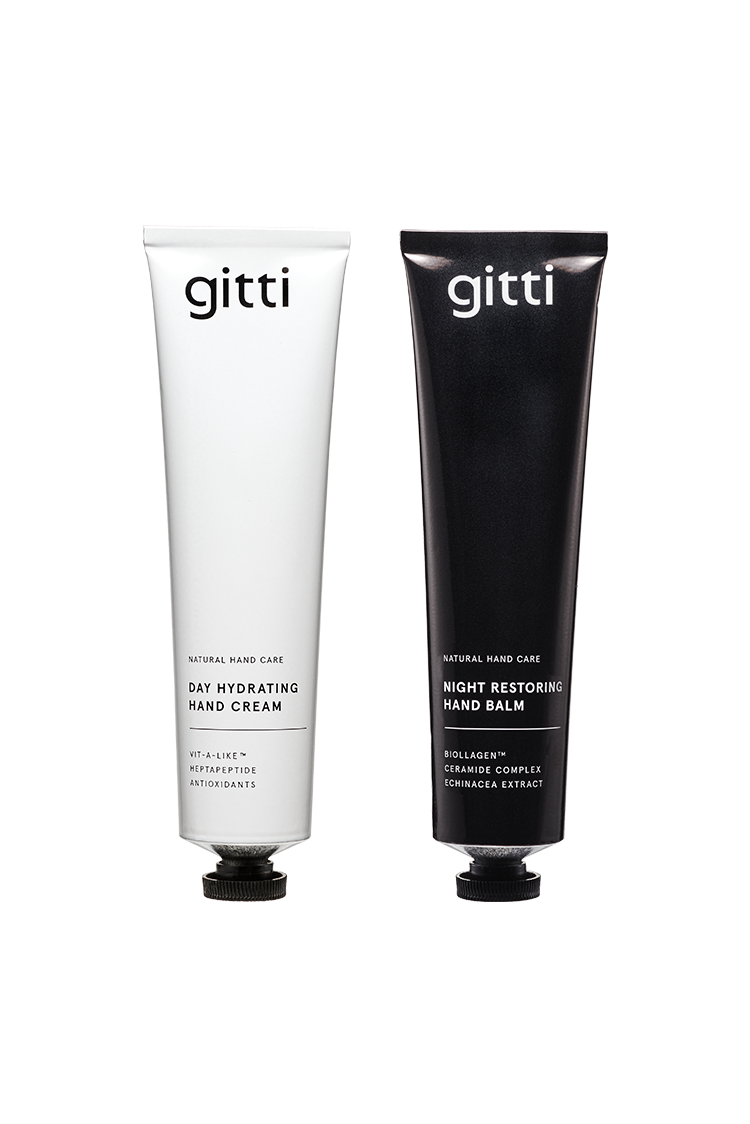 Zwei Tuben 24 Hour Hand Therapy - Day Hydrating Cream (weiß) und Night Restoring Balm (schwarz) - beide aufrecht stehend, bieten eine 24h-Pflegeroutine für spürbar weiche Hände.