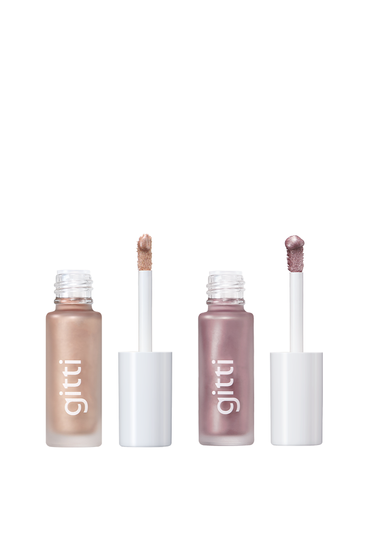 Das Halo Eyes Duo besteht aus zwei offenen Tuben mit flüssigem Metallic-Lidschatten mit weißer Kappe und Applikatoren in den Farben Bronze und Mauve mit der Aufschrift gitti-perfekt, um einen atemberaubenden Halo-Eye-Look vor einem weißen Hintergrund zu kreieren.