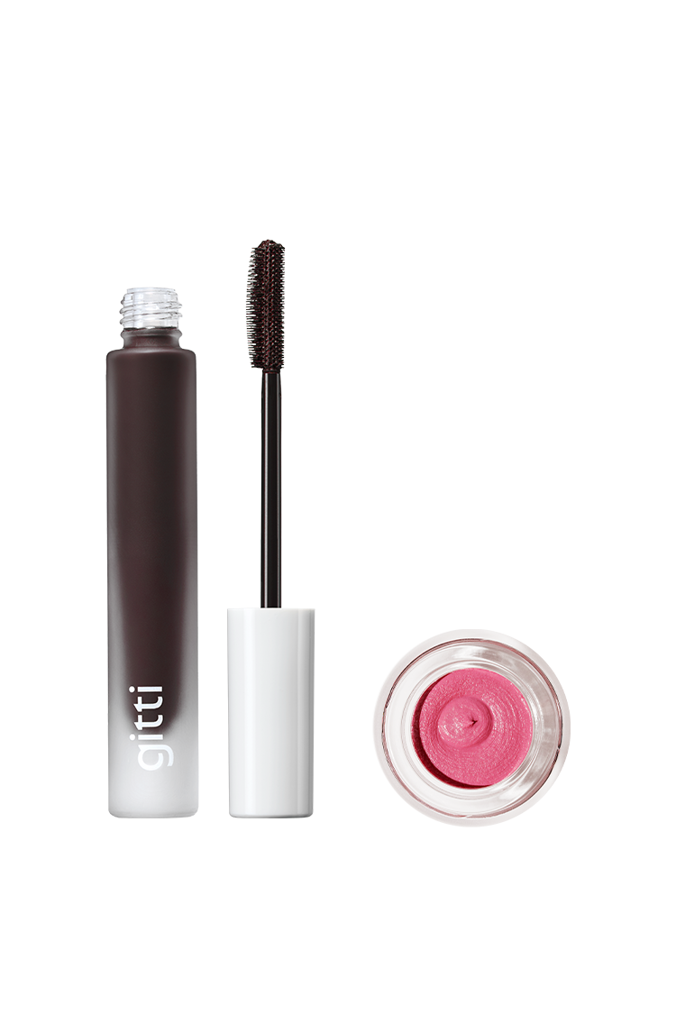 Das Lash & Cheek Duo besteht aus einer offenen schwarzen Wimperntusche mit weißer Kappe und Bürste sowie einem Tiegel mit rosa Creme-Make-up von Velvet Cheeks, die beide auf einem weißen Hintergrund angeordnet sind.