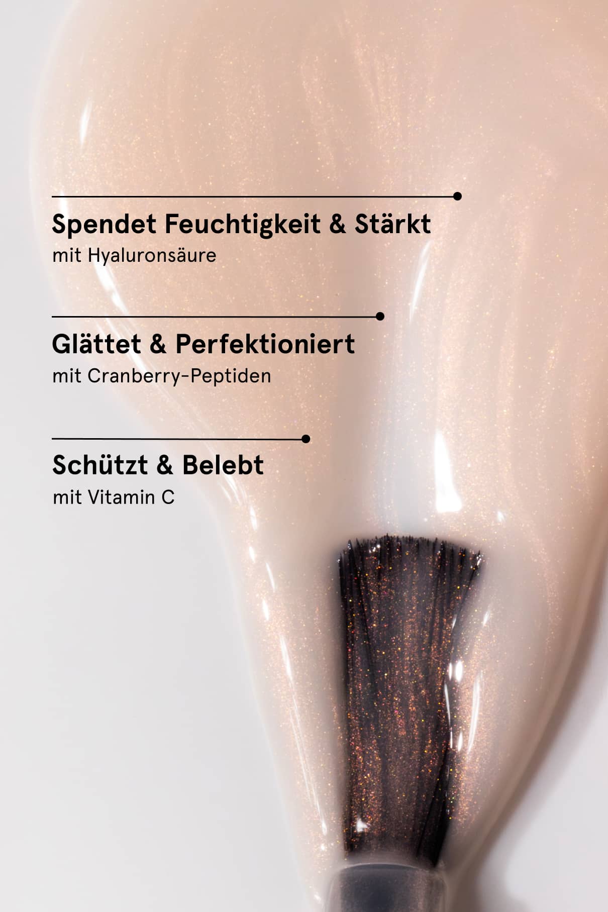 Macro shot of a shimmering pale pink nail tint on a brush against a peachy background.